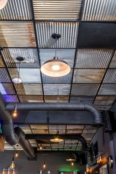 the interior of a restaurant with exposed pipes