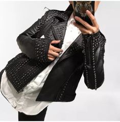 Introducing our Punk Women Black Leather Studded Jacket, the epitome of edgy and rebellious rock biker fashion. Crafted with meticulous attention to detail, this jacket is a must-have for any fashion-forward individual looking to make a bold statement. Constructed from high-quality leather, this jacket is designed to withstand the test of time, ensuring both durability and style. The genuine sheepskin shell exudes a luxurious feel, while the soft cotton and silk mix fabric lining provides superior comfort and breathability. Featuring a front zip fastening, this jacket effortlessly combines functionality with style. The zip closure allows for easy wear and adds a touch of modernity to the classic biker jacket design. Two side pockets provide ample storage space for your essentials, while an Indie Scene Style, Rocker Chic Style, Biker Fashion, Rocker Look, Punk Women, Leather Jacket Women, Studded Leather Jacket, Punk Clothing, Studded Jacket