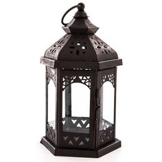 an ornate black metal lantern on a white background