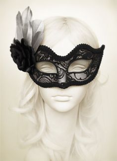 Venetian style masquerade mask covered black lace on metallic silver surface. Framed with black braided trim, small black rhinestones on the corners of the eyes. Decorated with black satin rose and silver feathers. Your order will be delivered with online tracking by UPS or TNT. Back surface is also covered with fabric for comfortable use. Ribbons are added both sides to tie. Base mask is made of paper mache. Standard size fits most (for women). This classical Venetian mask is perfect for any co Luxury Black Elegant Masks, Black Formal Eye Mask Masquerade, Black Formal Eye Mask, Formal Black Eye Mask, Elegant Black Formal Mask, Black Formal Masquerade Mask For Halloween, Elegant Black Mask For Costume Party, Elegant Black Masks And Prosthetics For Evening, Black Venetian Mask For Masquerade