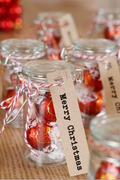 small glass jars filled with candy canes on top of a table