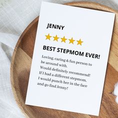 a piece of paper that says best stepmom ever sitting on top of a wooden plate