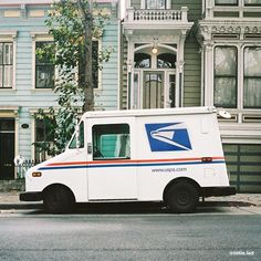 an postal truck parked in front of a house