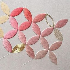 some pink and gold circles on a white surface