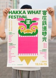 a person holding up a poster in front of their face with the words hakka what festival written on it