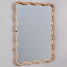 a mirror that is made out of wood and has wavy lines on the edge of it