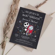 a halloween themed baby shower with skeleton and ghost on it's back, sitting next to some dead grass