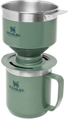 the stanley coffee pot is made from stainless steel and has a cup holder on top