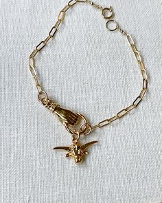 This playful piece features a long horn bull charm and a hand charm, both in gold plated silver, on a trendy 7 inch gold filled adjustable chain. Add a touch of whimsy to any outfit with this unique and stylish Bracelet. Cow Bracelet, Longhorn Bull, Charm Bracelet Gold, Long Horn, Stylish Bracelet, Western Jewelry, Hand Jewelry, Country Girl, Bracelet Gold