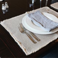 a place setting with silverware and napkins