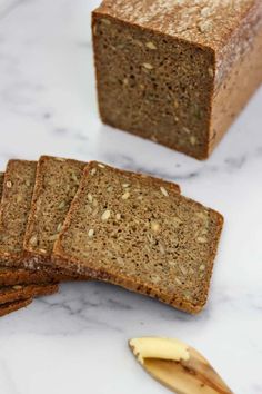 three slices of rye bread on a marble counter top with text overlay that reads easy overnight danish rye bread