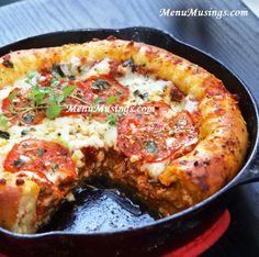 a pizza sitting in a pan on top of a table