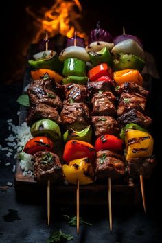 several skewers of meat and vegetables on sticks