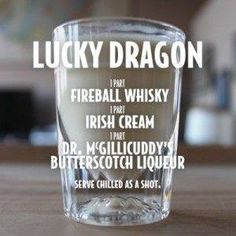 a shot glass sitting on top of a table with the words lucky dragon in it