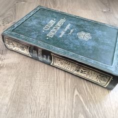 an old book sitting on top of a wooden table