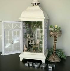 a doll house with furniture and accessories on a table