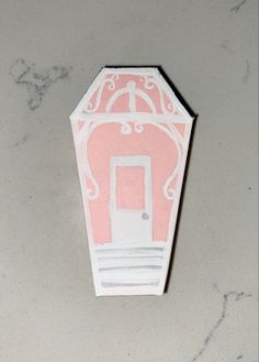 a pink and white box with a door on it