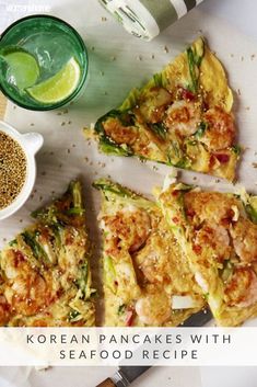 korean pancakes with seafood recipe on a plate next to a cup of green tea