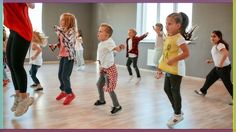 a group of young children dancing in a dance studio