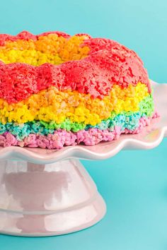 a cake that is covered in rainbow colored frosting