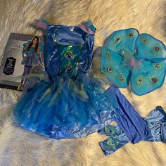 there is a blue dress and other items on the floor