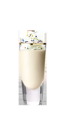 a tall glass filled with milk and sprinkles