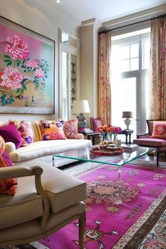 a living room filled with lots of furniture and flowers on the window sills