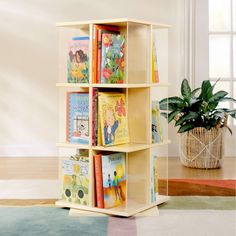 a book shelf with books on it and a potted plant in the corner next to it