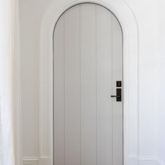 a white door with a black handle on the front and side panels in a room