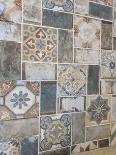 an assortment of different colored tiles on the wall