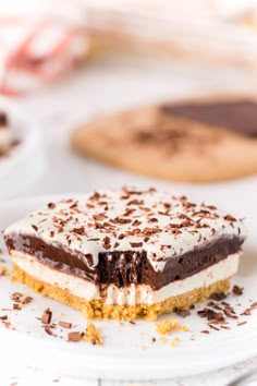 a piece of cake sitting on top of a white plate next to other desserts