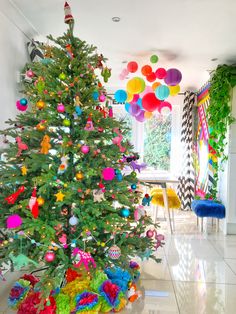 a brightly colored christmas tree in the middle of a room