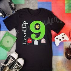 there is a t - shirt with the number nine on it next to two video game controllers