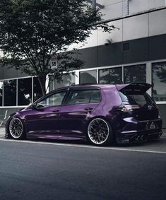 a purple car is parked on the side of the road