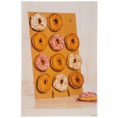 there are many doughnuts in the box on the table next to each other