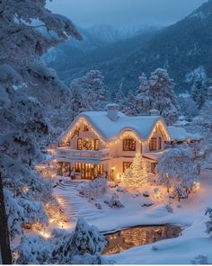 a large house covered in snow with christmas lights on it's windows and trees