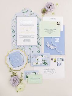 the wedding stationery is laid out on top of each other