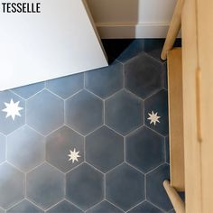 an overhead view of a tiled floor with white stars on it and the words tesselle above it