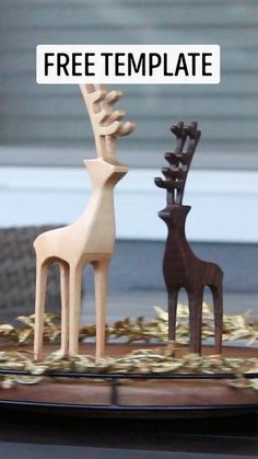 three wooden deer sculptures sitting on top of a table