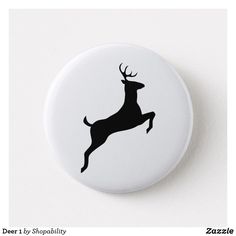 a white button with a black silhouette of a leaping deer on it's side