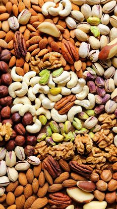 nuts and pistachios spread out on top of each other in different colors