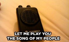 a person holding a black radio in their hand with the words let me play you the song of my people