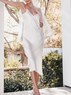 Elegant V-neck Slip Dress For Wedding, Elegant V-neck Bridesmaid Wedding Dress, White Ethereal Dress For Evening, Elegant Silk Mother Of The Bride Dress For Wedding, Ethereal White Evening Dress, Elegant Bridesmaid Slip Dress With Fitted Bodice, Elegant V-neck Gown For Wedding Night, Elegant Silk Mother Of The Bride Dress, Feminine Embroidered Midi Dress For Wedding