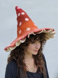 a woman wearing a red and white polka dot hat