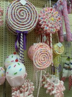 some lollipops are hanging on the wall in a store with other decorations