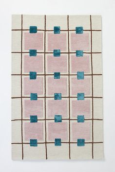 a pink and blue rug with squares on it