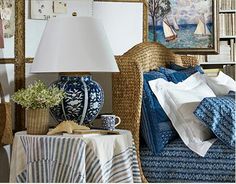 a living room filled with lots of furniture next to a lamp and bookshelf