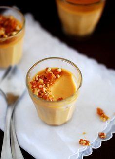 two small glasses filled with food on top of a table