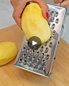 a person grating cheese with a grater on a cutting board next to a banana