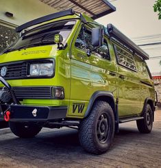 a green van parked in front of a building